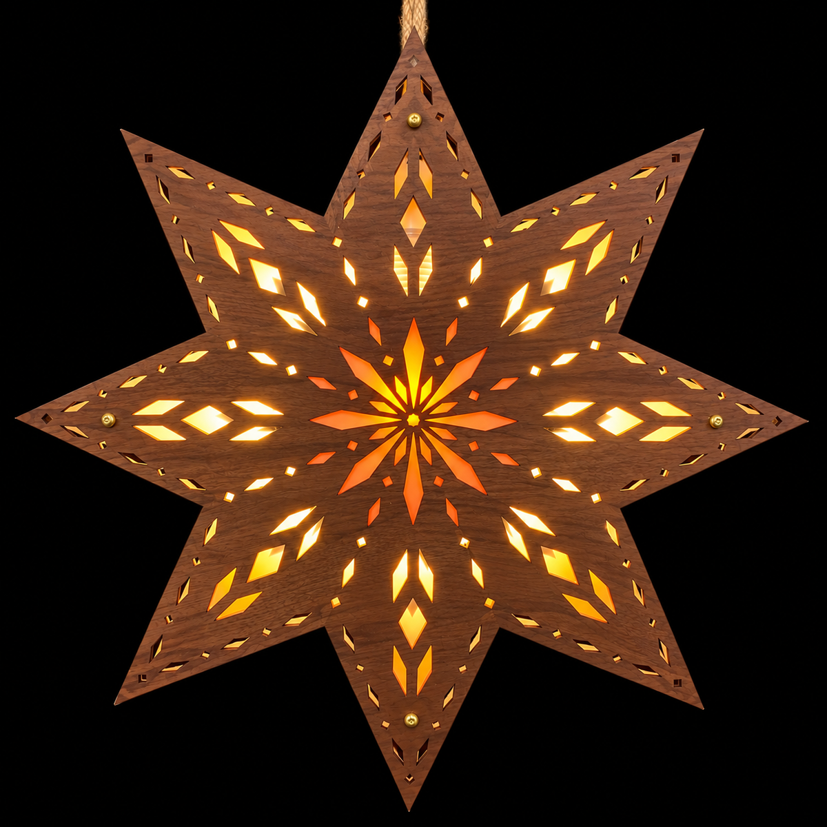 Dark walnut-toned Scandinavian wooden star window light glowing against a black background with intricate geometric openings and orange starburst center.