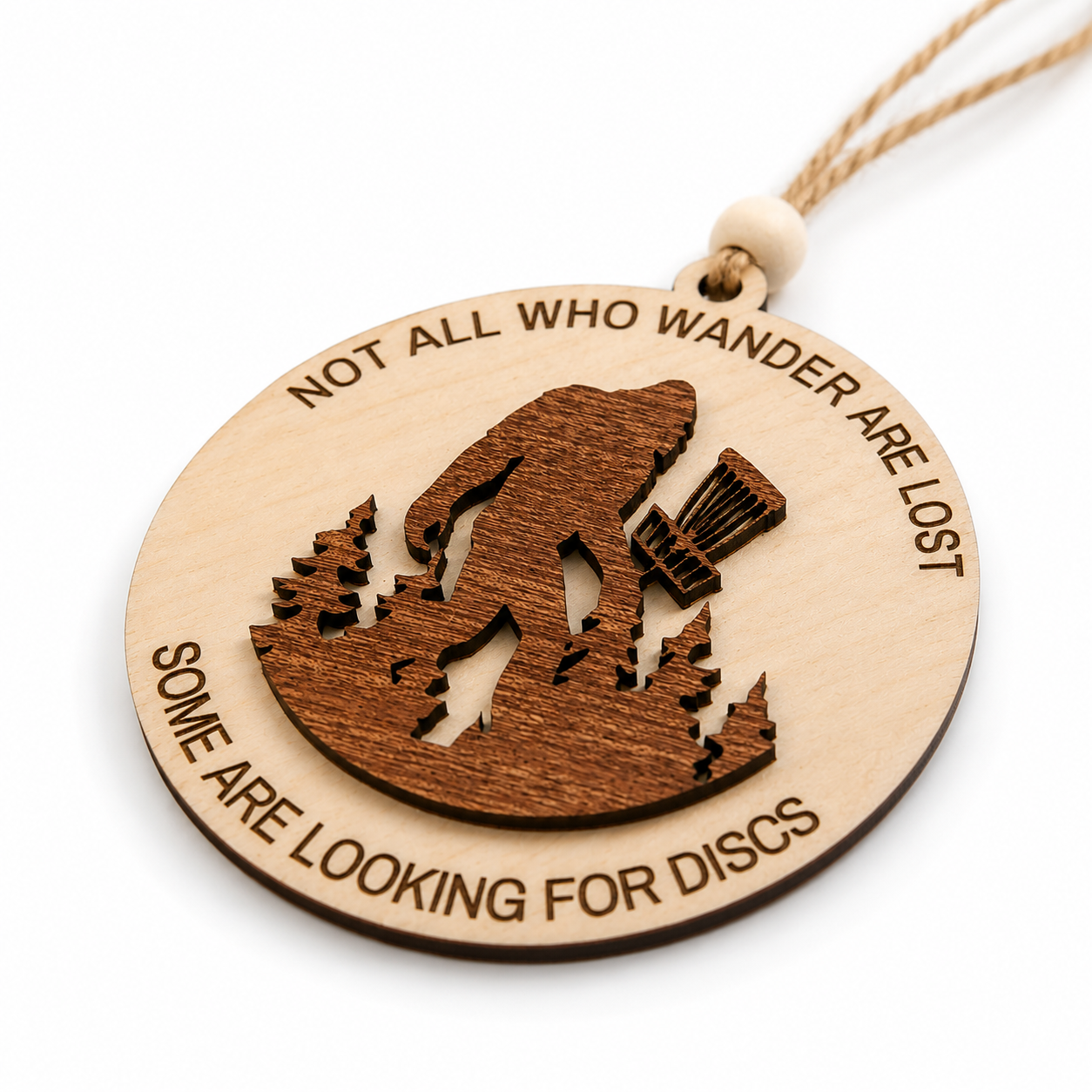 Angled view of a handcrafted layered wood Bigfoot disc golf ornament highlighting the detailed laser-cut construction.