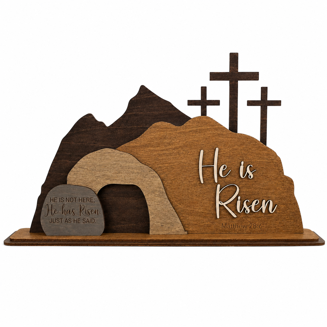 He Is Risen wooden resurrection scene on a white background featuring the empty tomb, Calvary crosses, layered wood construction, and Matthew 28:6 Bible verse.