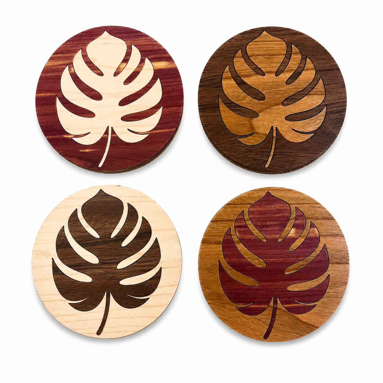 Handmade Monstera wood coaster set of four on a white background featuring walnut, maple, cherry, and cedar hardwood.