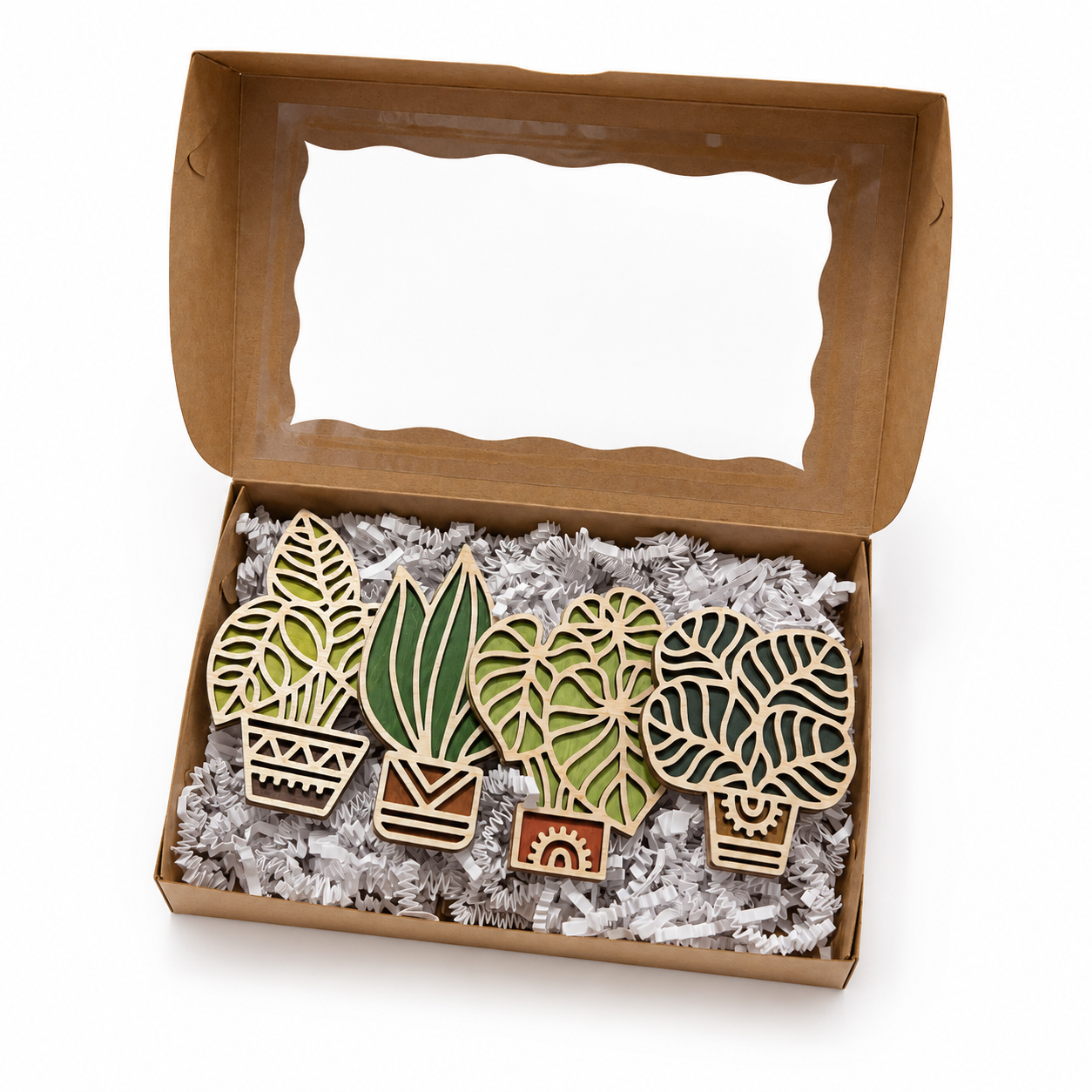 Gift-ready box filled with handmade wooden houseplant magnets nestled in white paper filler packaging.