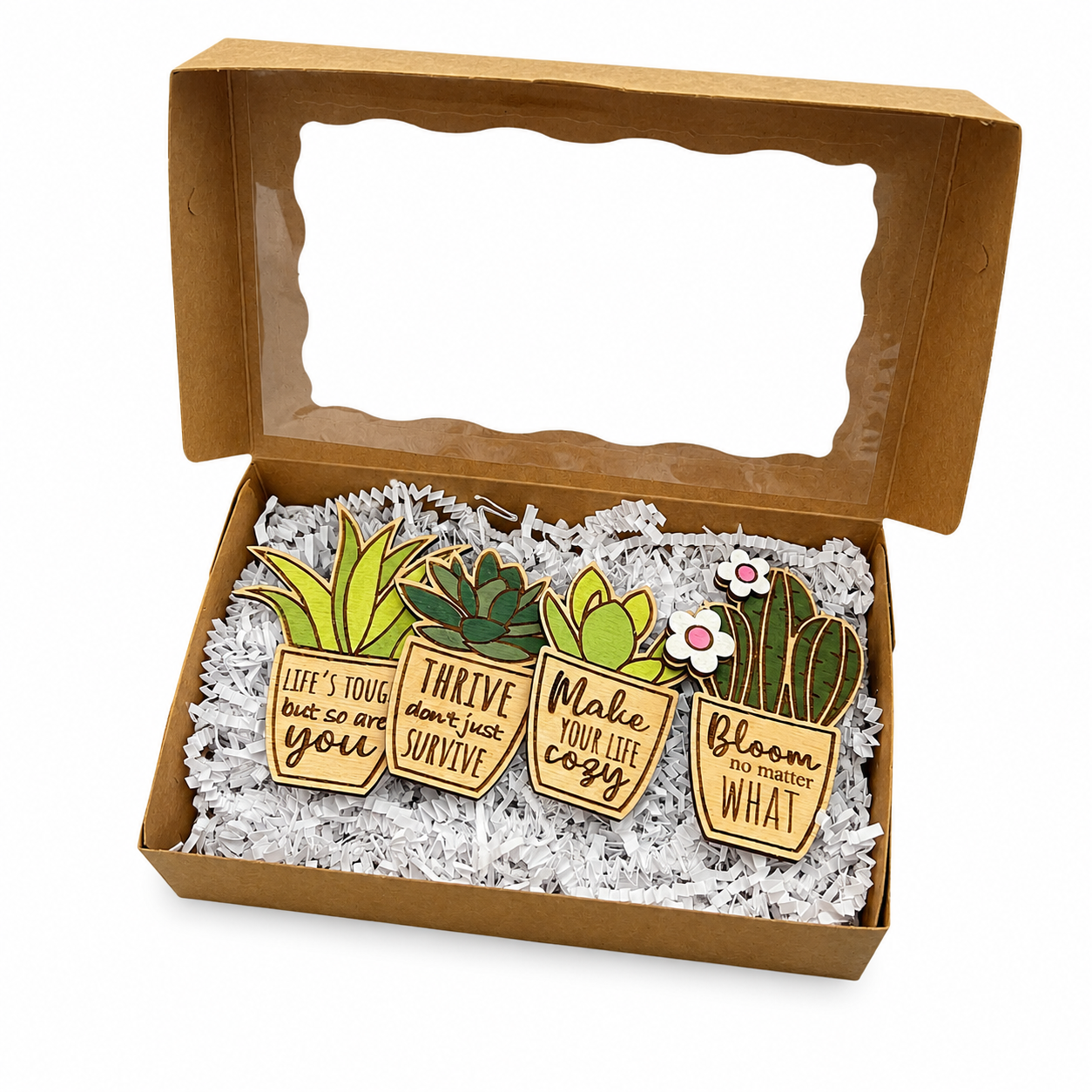 Open gift box displaying four handmade wooden succulent magnets with motivational sayings, laser cut plant magnets nestled in shredded paper filler