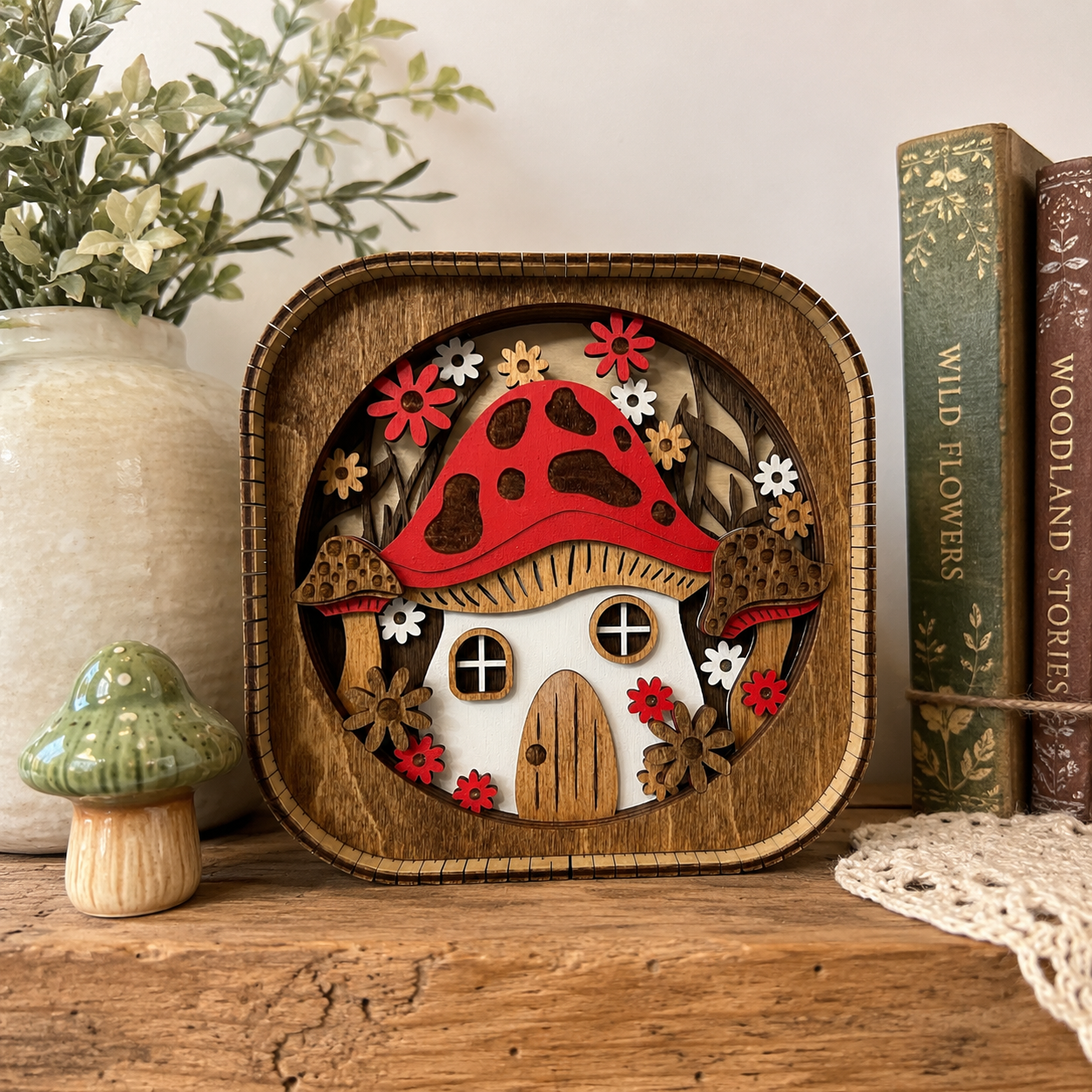 3D wood mushroom house shelf sitter displayed on a rustic shelf with cottagecore woodland decor accents