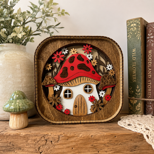 3D wood mushroom house shelf sitter displayed on a rustic shelf with cottagecore woodland decor accents