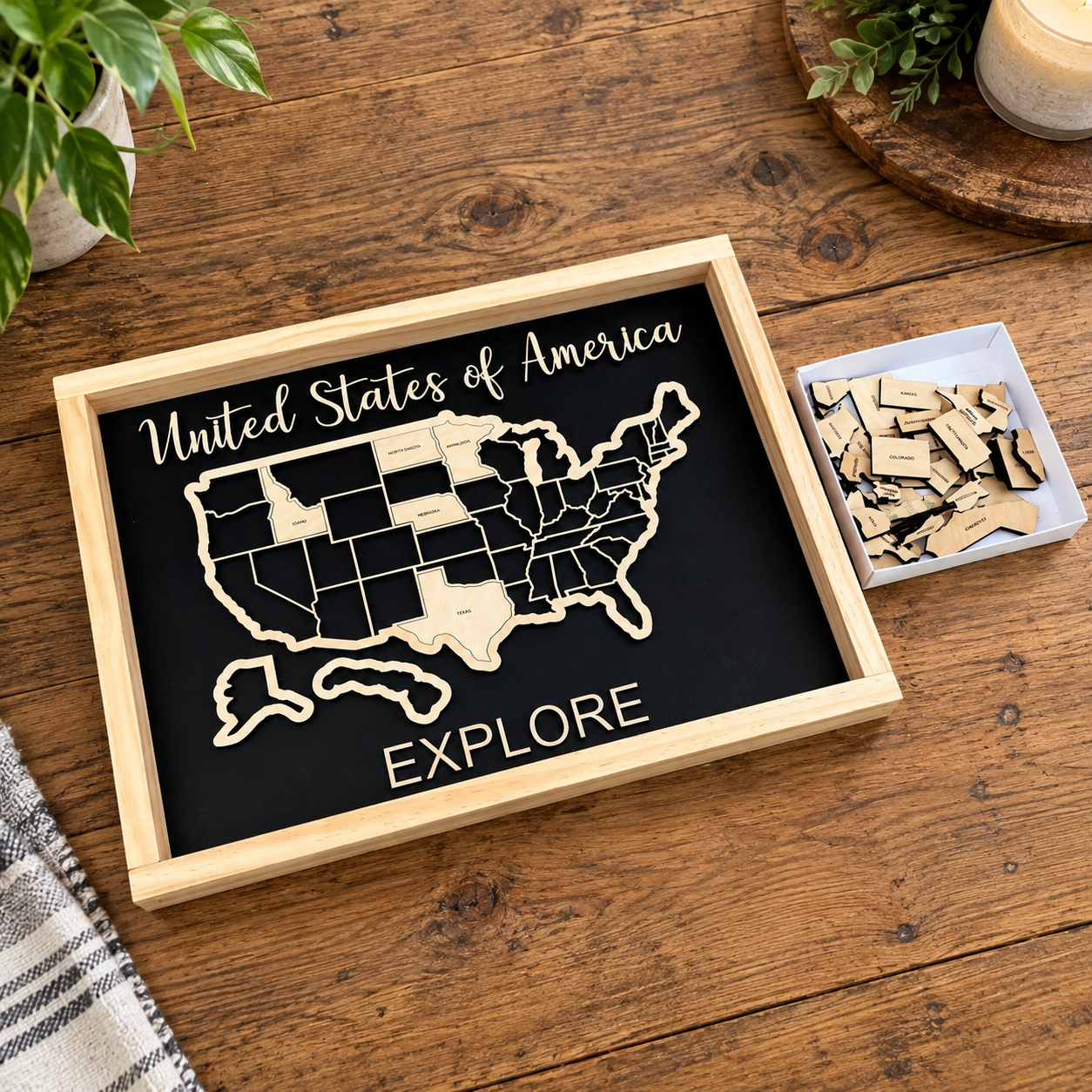 Handmade wooden USA travel map with removable state pieces, black background and natural pine frame