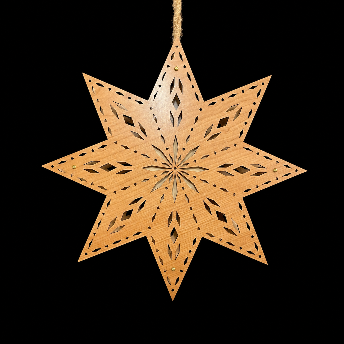 Unlit Scandinavian wooden star window light displaying natural hardwood grain, eight pointed star shape and intricate laser-cut geometric pattern.