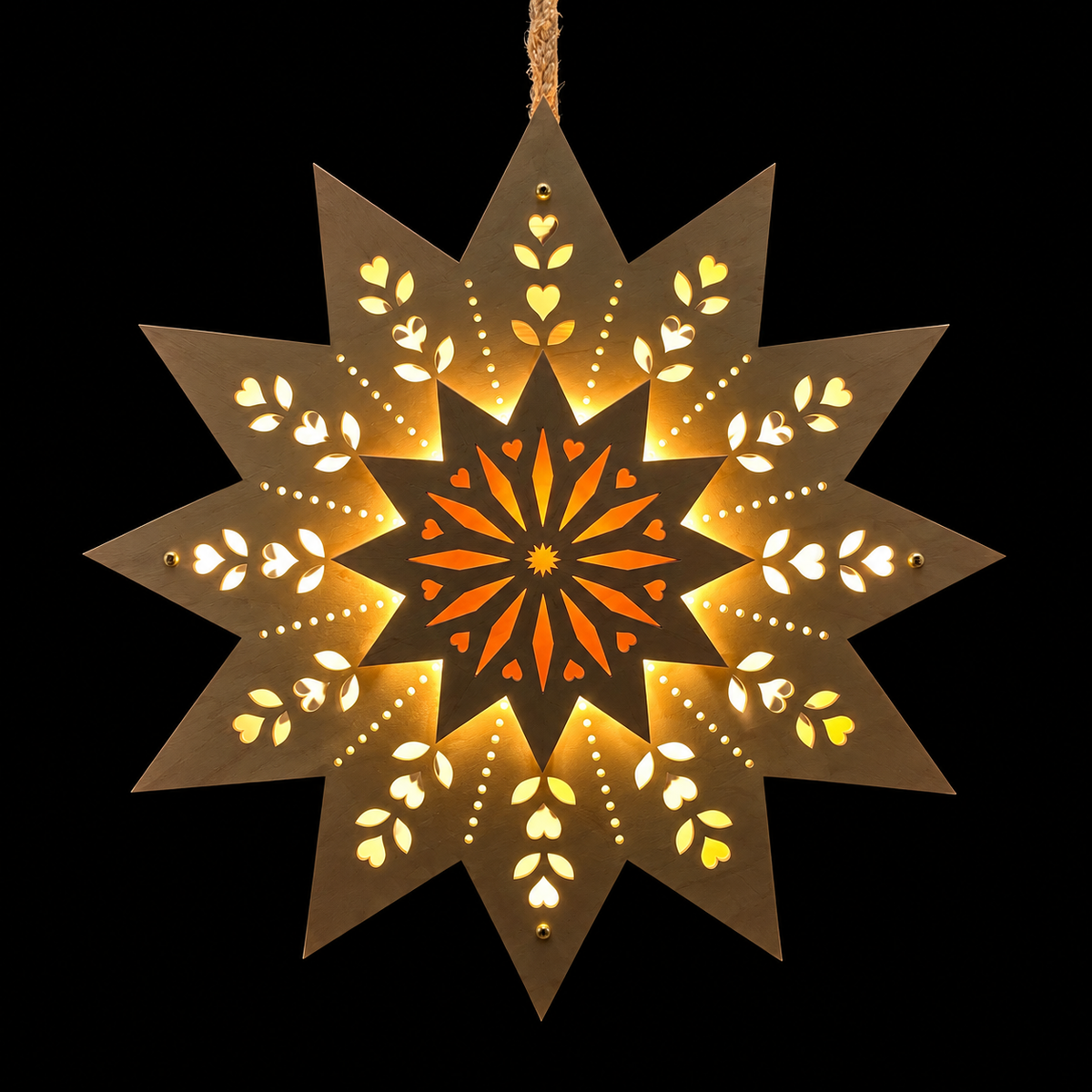 Front view of an illuminated maple wooden Welcome Light with a raised starburst center and warm light glowing through decorative heart and leaf cutouts.