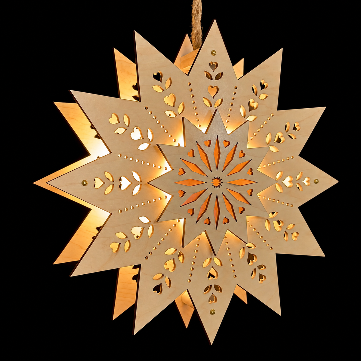 Illuminated Scandinavian wooden Welcome Light Design #6 with a raised starburst center, heart and leaf cutouts, and warm golden glow against a black background.
